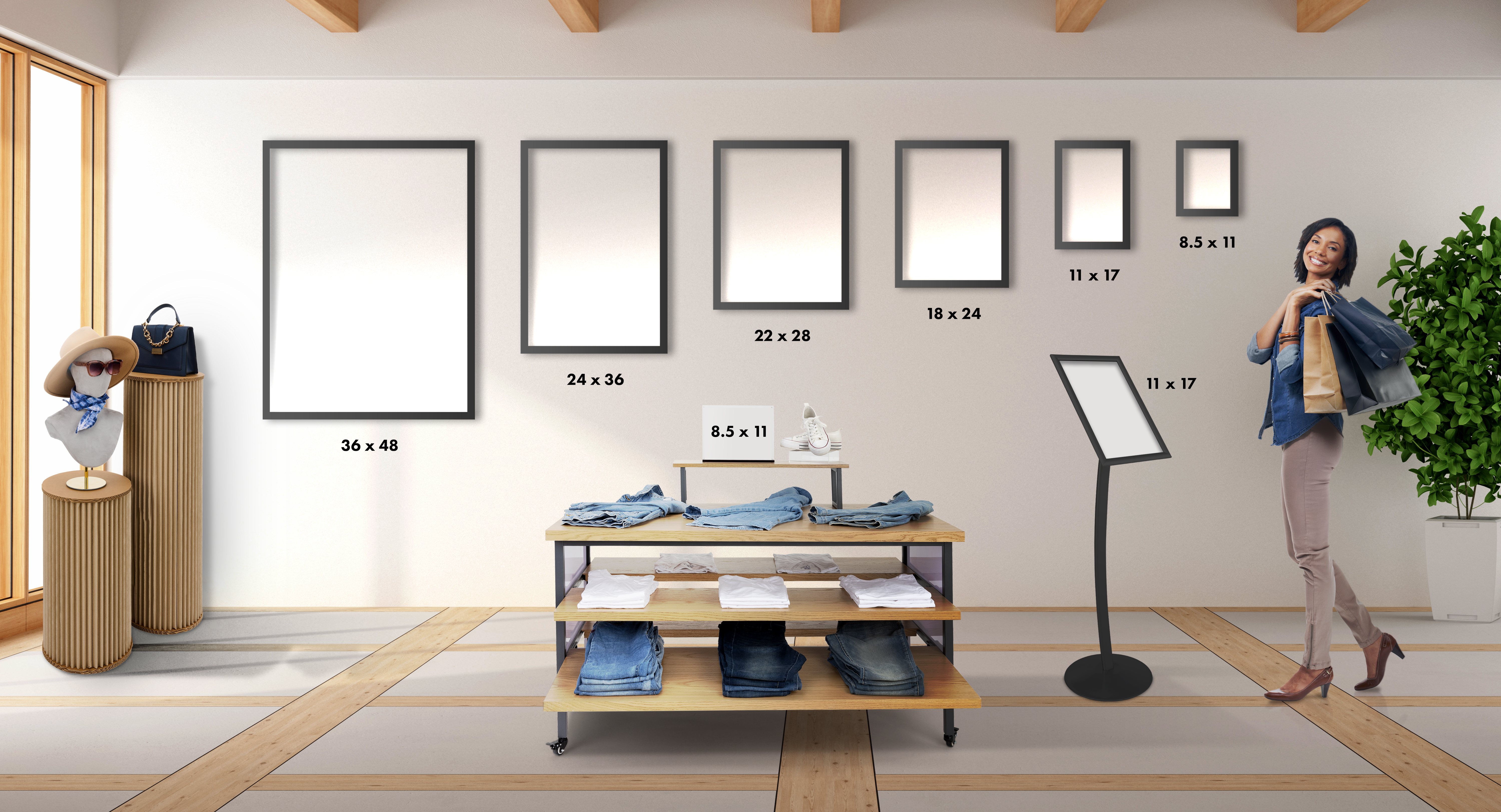 Image showcasing size proportions of 8.5x11, 11x17, 18x24, 22x28, 24x36, and 36x48 frames on the wall in a retail environment with woman and display table for scale